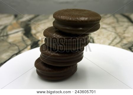 A Round Biscuits Covered In Chocolate Broken In Half