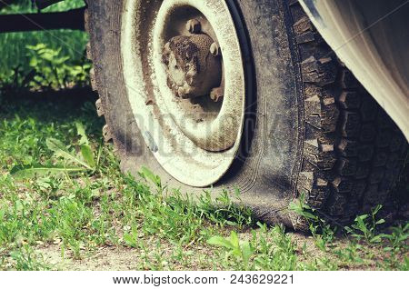 Flat Tire On The Suv Close Up. Abstract Background.
