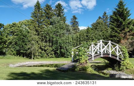 A Little Wooden Bridge Across The Little Pond.