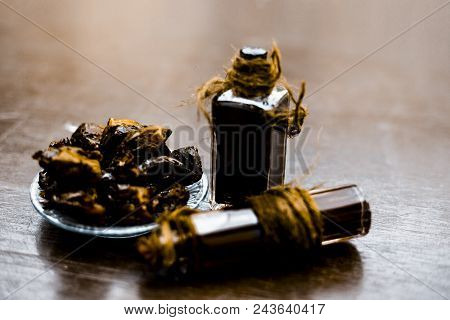 Sweet And Floral Essence Of Date Or Khajoor In Bottles On Wooden Surface Used I Flavored Chocolate A