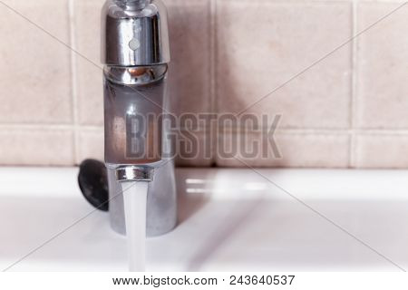Open Faucet Letting The Water Run. Wasting Water.