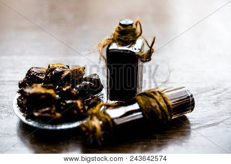 Sweet And Floral Essence Of Date Or Khajoor In Bottles On Wooden Surface Used I Flavored Chocolate A