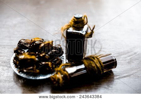 Sweet And Floral Essence Of Date Or Khajoor In Bottles On Wooden Surface Used I Flavored Chocolate A