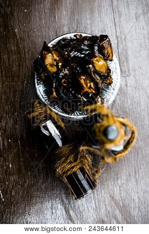 Sweet And Floral Essence Of Date Or Khajoor In Bottles On Wooden Surface Used I Flavored Chocolate A