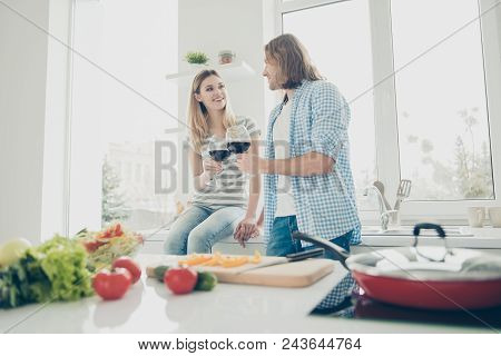 Low Angle View Portrait Of Lovely Romantic Couple Holding Glasswines In Hands Drinking Alcohol Bever