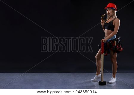 Sex Equality And Feminism. Sexy Girl In Safety Helmet Holding Hammer Tool. Attractive Woman Working 
