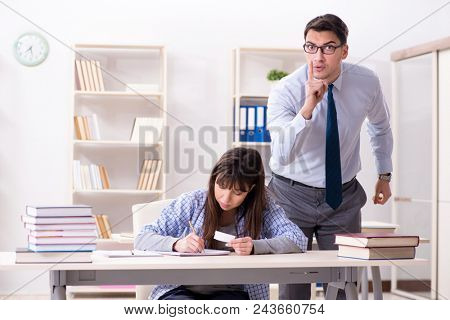 Male lecturer giving lecture to female student