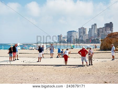 El Campello, Spain - May 22, 2018: Petanque Players On The Beach Of El Campello. Petanque Is A Game 