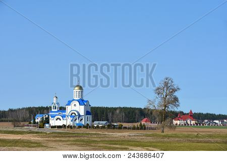 The Landscape Of The White Church Stands Full On The Edge Of The Village In The Spring