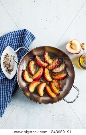 Fried Pieces Of Peaches In A Frying Pan On The Table. Cooking.