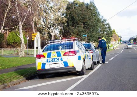 Bulls, New Zealand - 2 July 2016: A Police Officer Pulls Over A Speeding Driver On The Main Road Of 