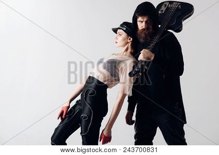 Stylish Hipster And Woman Together With Electric Guitar. Rock Couple Of Sexy Girl And Bearded Man Wi