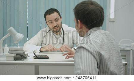 Male Bearded Doctor In Clinic Offer Good Price For Treatment