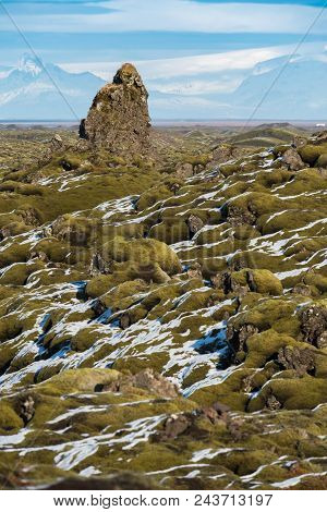 Moss-covered Rock Outcroppings In The Eldrhaun Lava Fields Of Iceland With Mountains And Glaciers In