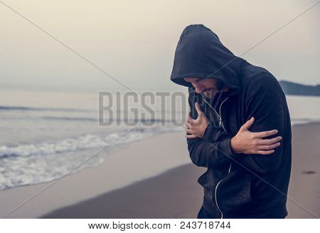 Caucasian man walking alone at the beach