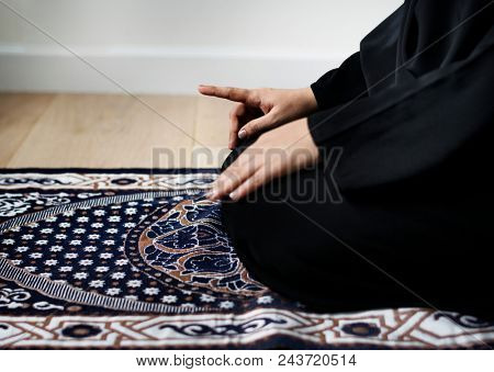 Muslim woman praying in Tashahhud posture