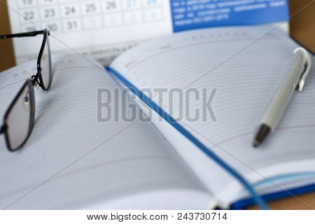 Notebook With A Calendar For Notes On The Desktop