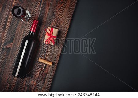 Bottle Of Wine Gift Box Corkscrew And Wineglass On Rusty Background Up Wiev