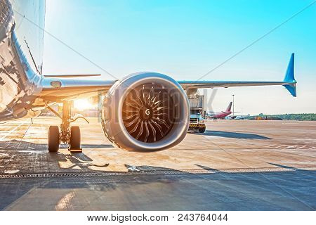 Airplane Is Parked At The Airport Before Departure, The View On The Wing Of The Chassis Rack Gear En