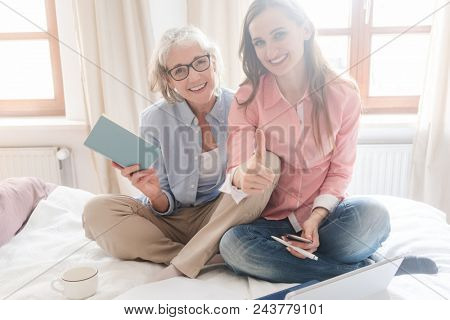 Senior and young woman working together as freelancers from home