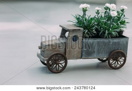 Flower Delivery. Toy Car With Flowers, Focus On The Foreground. Flower Delivery Concept