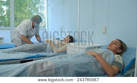 Nurse Preparing Patient's Vein In Order To Put Iv Tube