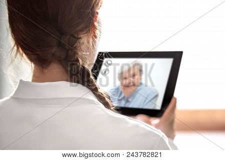 Doctor´s Consultation With Telemedicine Or Telehealth, Elderly Woman On The Display From A Tablet, C