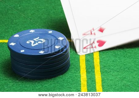 Column Of Blue Poker Chips And Two Falling Ace On A Green Canvas Concept Of Casino And Board Games