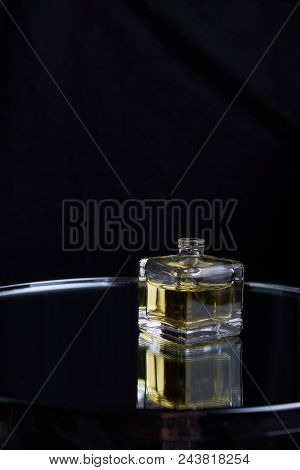 Bottle Of Perfume Spraying, Isolated On Black Background