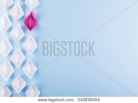 One Unique Pink Paper Boat Among Many Ones. Different Paper Ships As Think Different And Creativity 