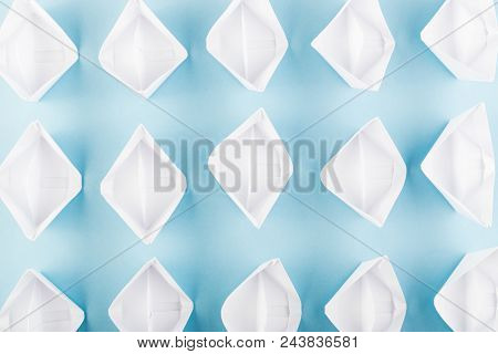 White Paper Boats Or Paper Ships Origami On Blue Background Top View