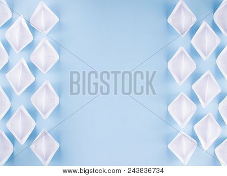 White Paper Boats Or Paper Ships Origami On Blue Background Top View With Place For Text
