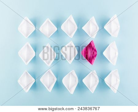 One Unique Pink Paper Boat Among Many Ones. Different Paper Ships As Think Different And Creativity 