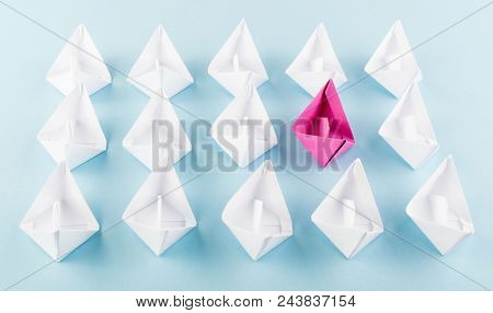 One Unique Pink Paper Boat Among Many Ones. Different Paper Ships As Think Different And Creativity 