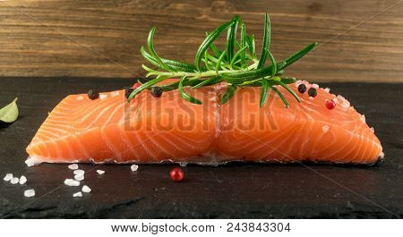 Slice Of Salmon Fillet. Thick Piece Of Fresh Red Fish Or Trout On Natural Black Background