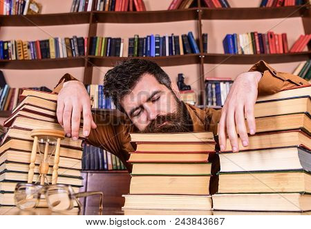Teacher Or Student With Beard Fall Asleep On Books, Defocused. Man On Sleeping Face Lay Between Pile