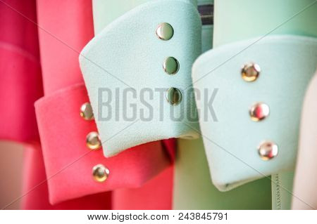 Colorful softshell coats on rack with hangers. Fashion conception.
