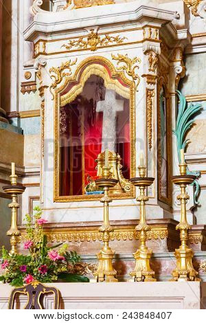 Obidos, Portugal - August, 2015: The stone cross placed in the altar is the relic of the Sanctuary of Senhor do Jesus da Pedra. Baroque architecture.