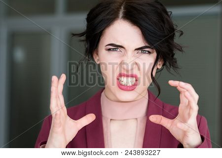 Emotion Face. Enraged Infuriated Woman Baring Her Teeth. Female Ready To Kill Or Strangle With Hands