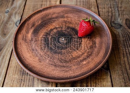 A Ripe Juicy Red Strawberry On A Plate