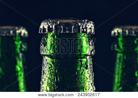 Necks Of Sealed Beer Bottles With Condensation On Black Background. Close Up, Party, Pub, Concept Ok