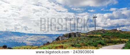 Wind turbine generator on top a hill for the production of clean and renewable energy near Fafe, Portugal
