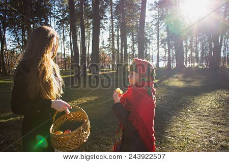 Young Pretty Girl With Daughter At Red Scarf On Her Head In The Spring Forest
