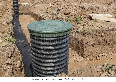 View Of Drainage Pipes And Inspection Well For Removal Of Water From A Site Under Construction Of Th
