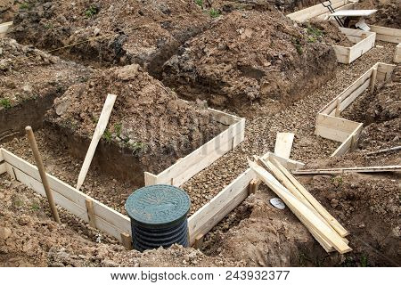 Inspection Well, Drainage Pipe And Trench With Formwork, Which Is Prepared For Pouring The Foundatio