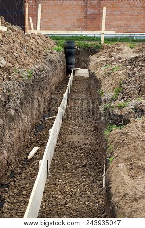 Inspection Well, Drainage Pipe And Trench With Formwork, Which Is Prepared For Pouring The Foundatio