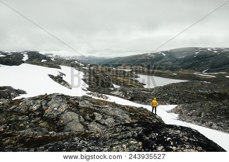Typical norwegian landscape with snowy mountains and clear lake near the famous Aurlandsvegen (Bjorgavegen), mountain road, Aurland, Norway.