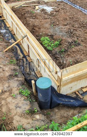 Inspection Well And Trench With Wooden Formwork. Preparation For Pouring The Foundation
