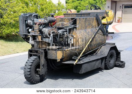 Slurry Machine lays down hot slurry to reseal a blacktop driveway, street rehabilitation and slurry seal project finished with crews expertly applying the slurry seal. 
