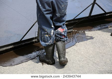 Private drive way, street rehabilitation and slurry seal project finished with crews expertly applying the slurry seal. Re-surfaced Cul-de-sac shown with unidentifiable crew working


